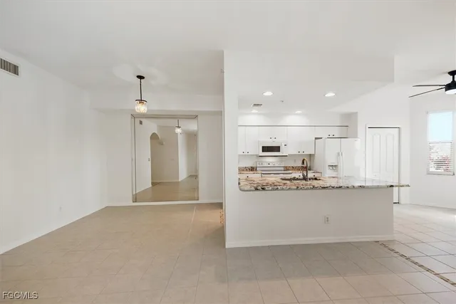a view of large kitchen with stainless steel appliances kitchen island