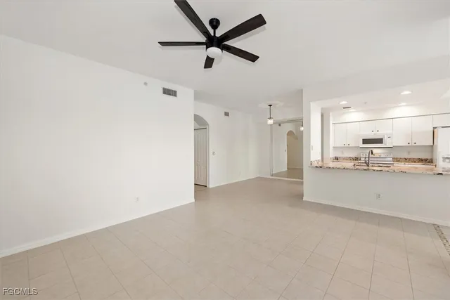 a view of a kitchen with a sink and stainless steel appliances