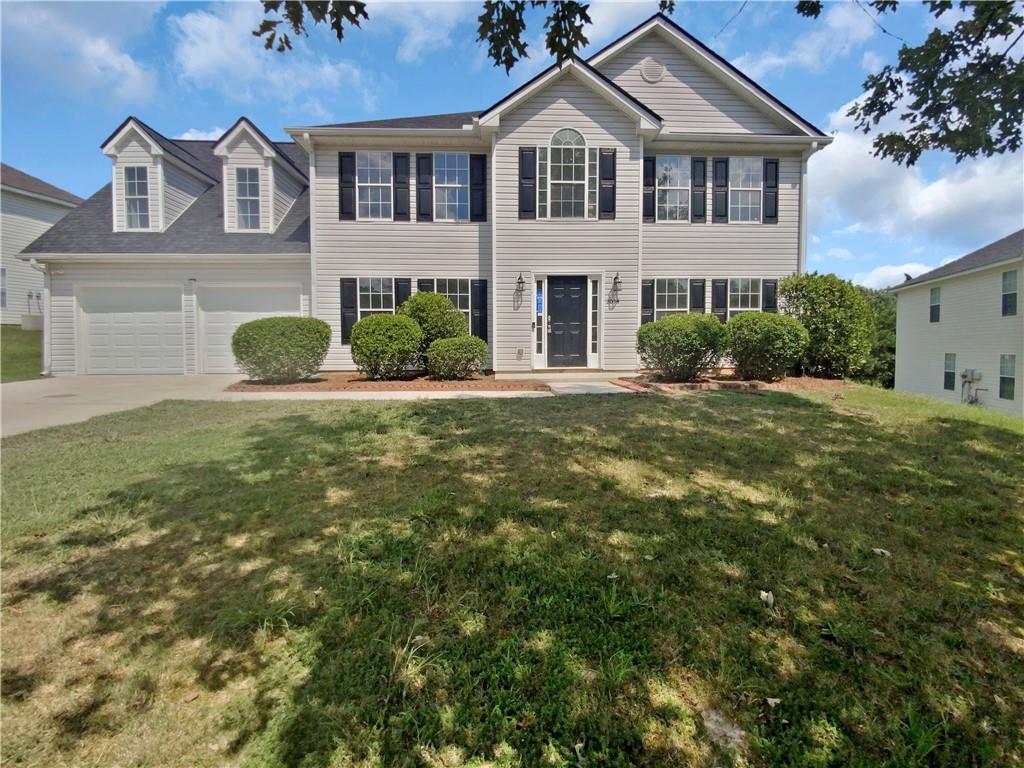 2034 Locksley Terrace Lithonia, GA 30058 - Photo 1 of 1 a front view of a house with a yard