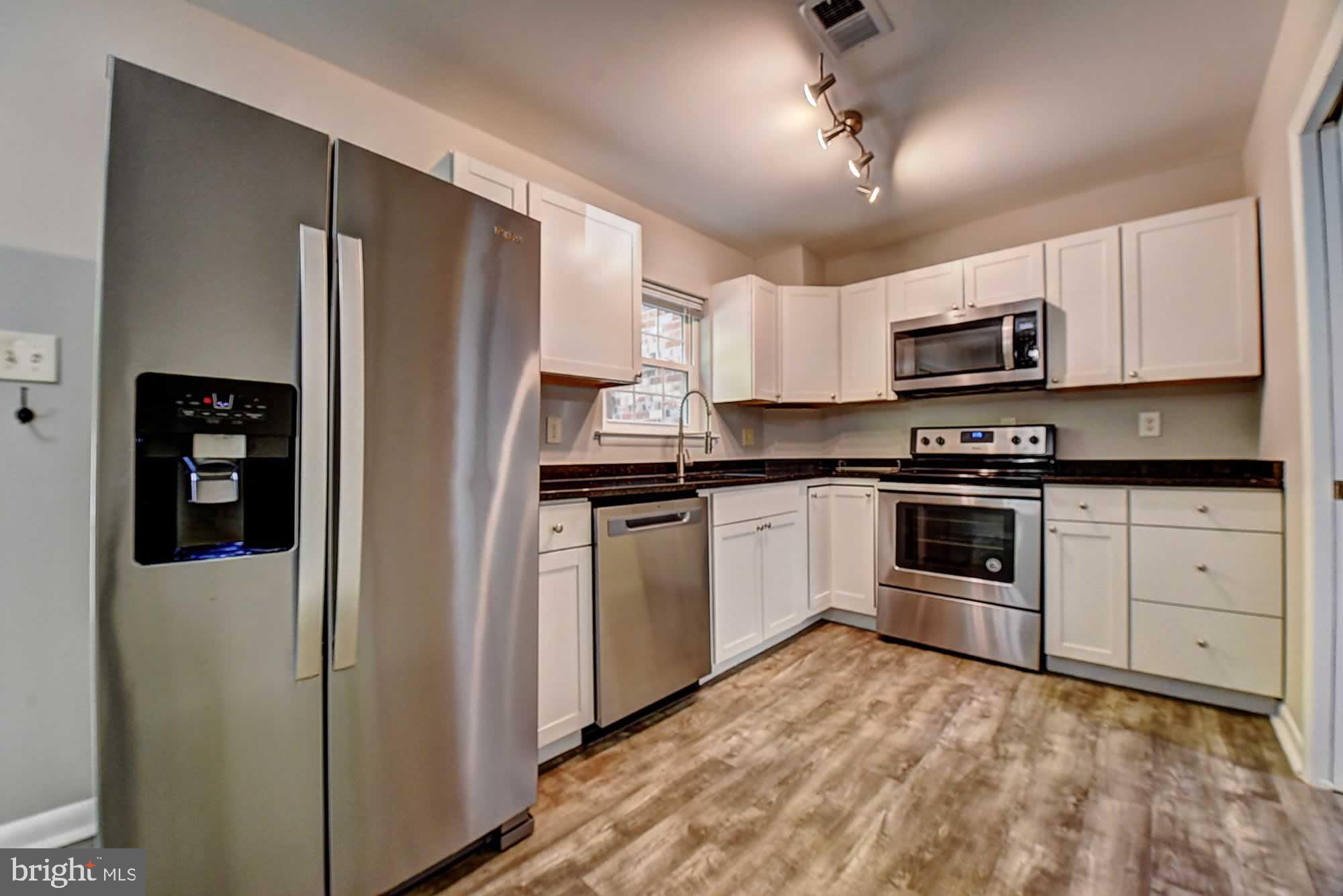 2226 Gunsmith Square Reston, VA 20191 - Photo 14 of 35 a kitchen with white cabinets and refrigerator