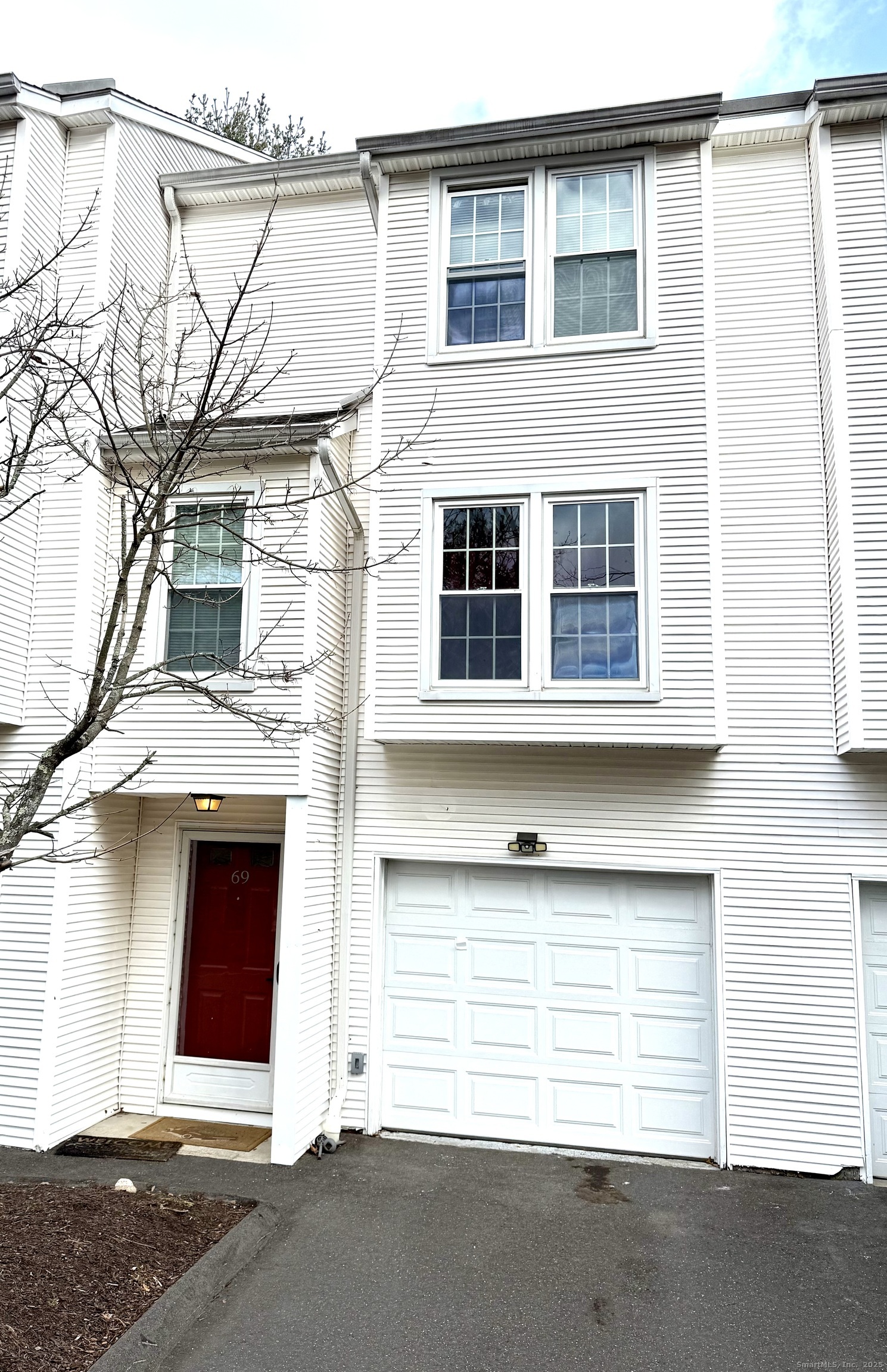 380 Hitchcock Road, Unit 69 Waterbury, CT 06705 - Photo 1 of 1 a front view of a house with a garage
