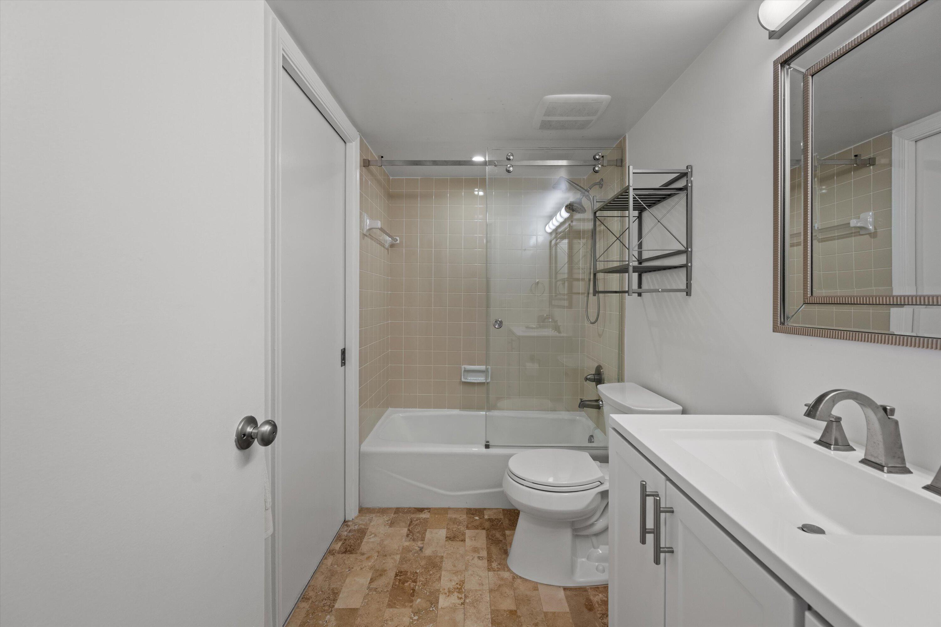 13400 Polo Road West, Unit 203 Wellington, FL 33414 - Photo 21 of 26 a bathroom with a toilet sink and shower