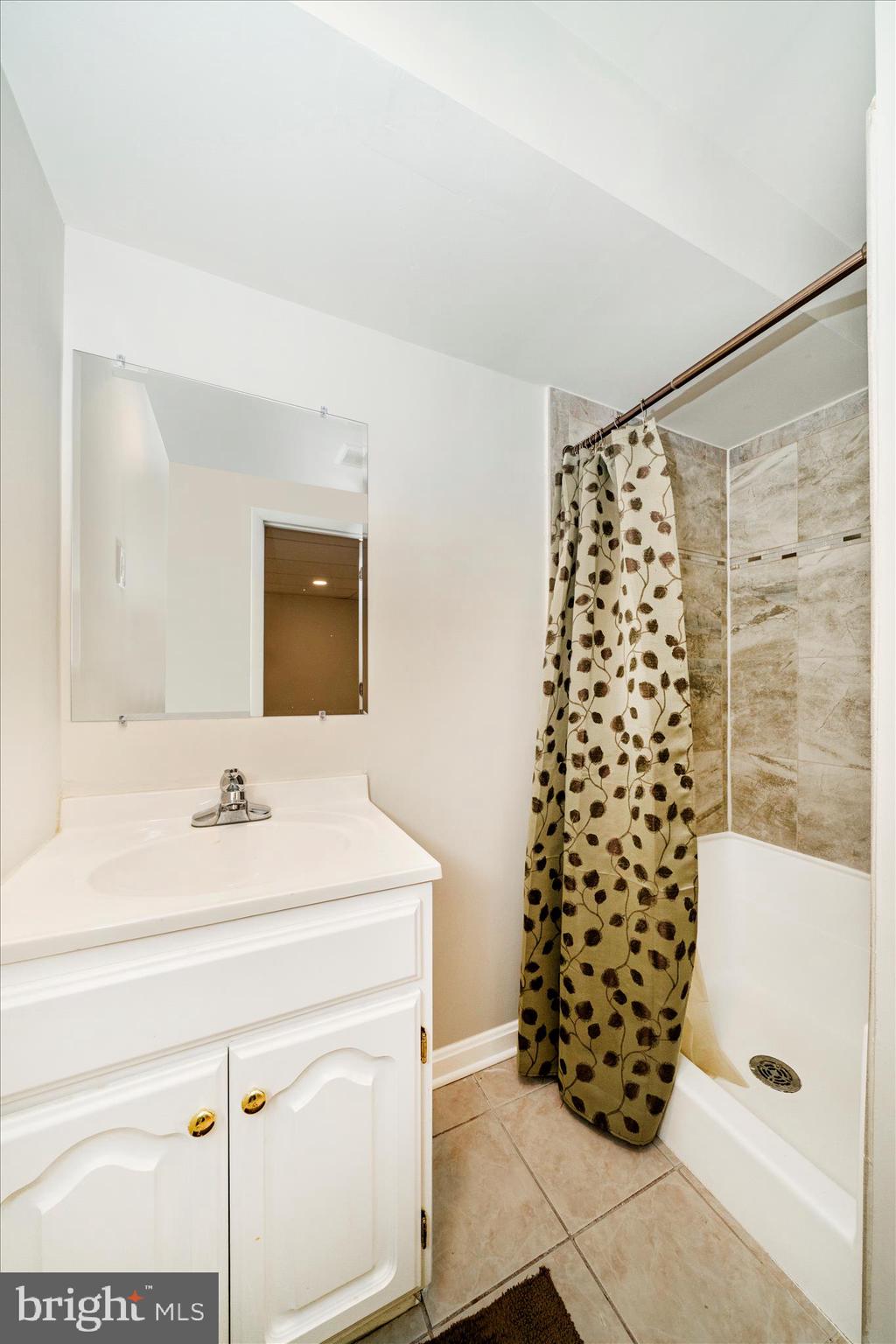 16000 Narrows Terrace Silver Spring, MD 20906 - Photo 40 of 54 a bathroom with a sink a vanity and a shower
