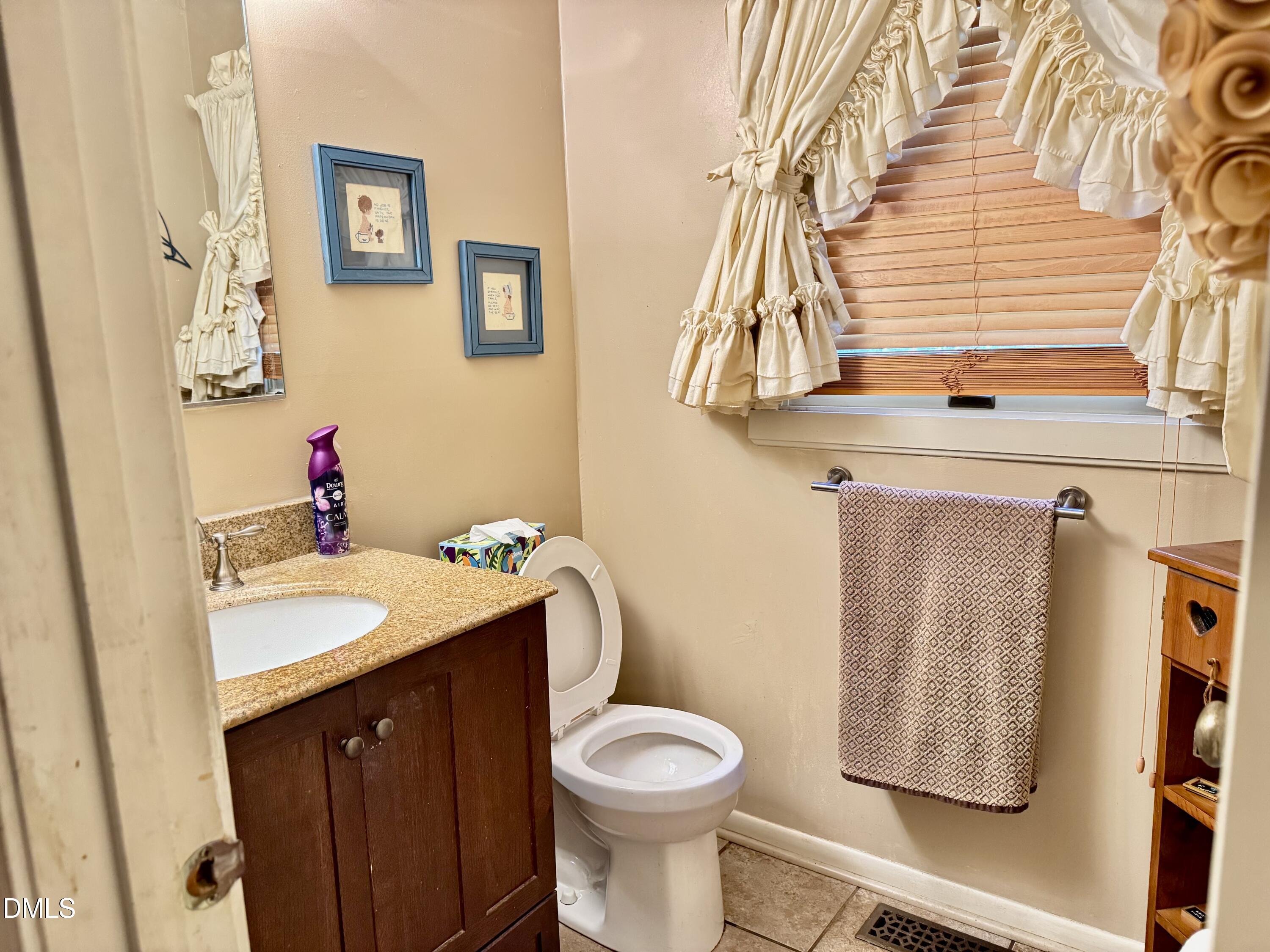 84 Wintergreen Road Henderson, NC 27537 - Photo 18 of 49 a bathroom with a sink toilet and vanity