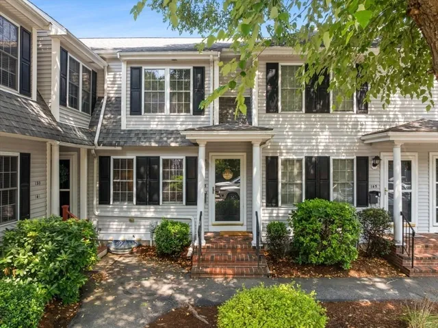front view of a brick house with a yard
