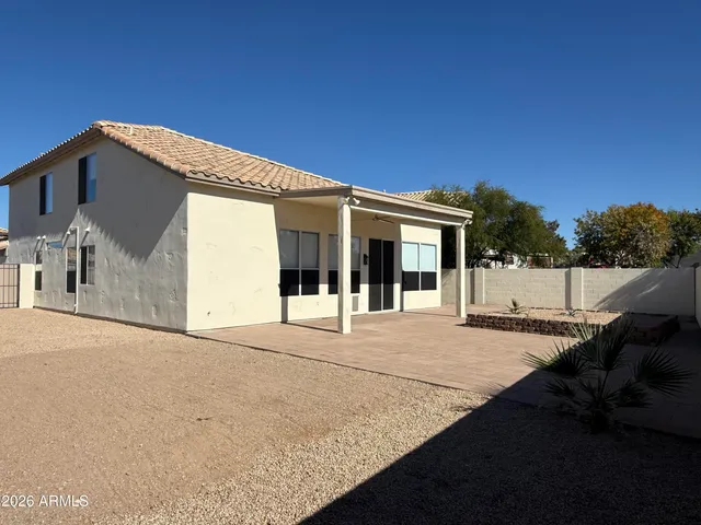 a view of a house with backyard and a tree