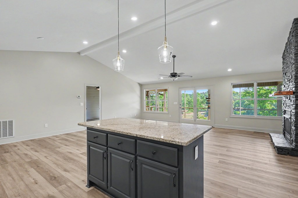 456 Deaver Cove Road Blairsville, GA 30512 - Photo 17 of 83 a kitchen with a sink chandelier and wooden floor