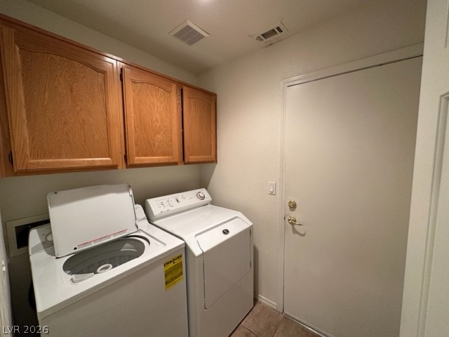 285 Spring Palms Street Henderson, NV 89012 - Photo 20 of 38 Clothes washing area featuring separate washer and dryer, cabinet space, light tile patterned flooring, and visible vents