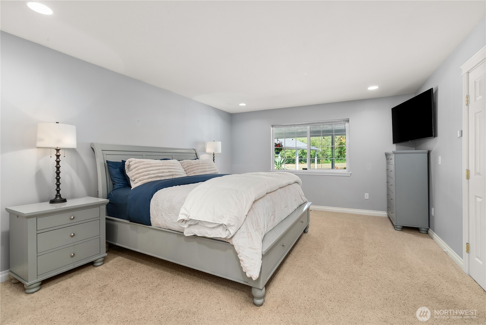 46 Richard Lane Elma, WA 98541 - Photo 11 of 40 a bedroom with a bed and a flat screen tv