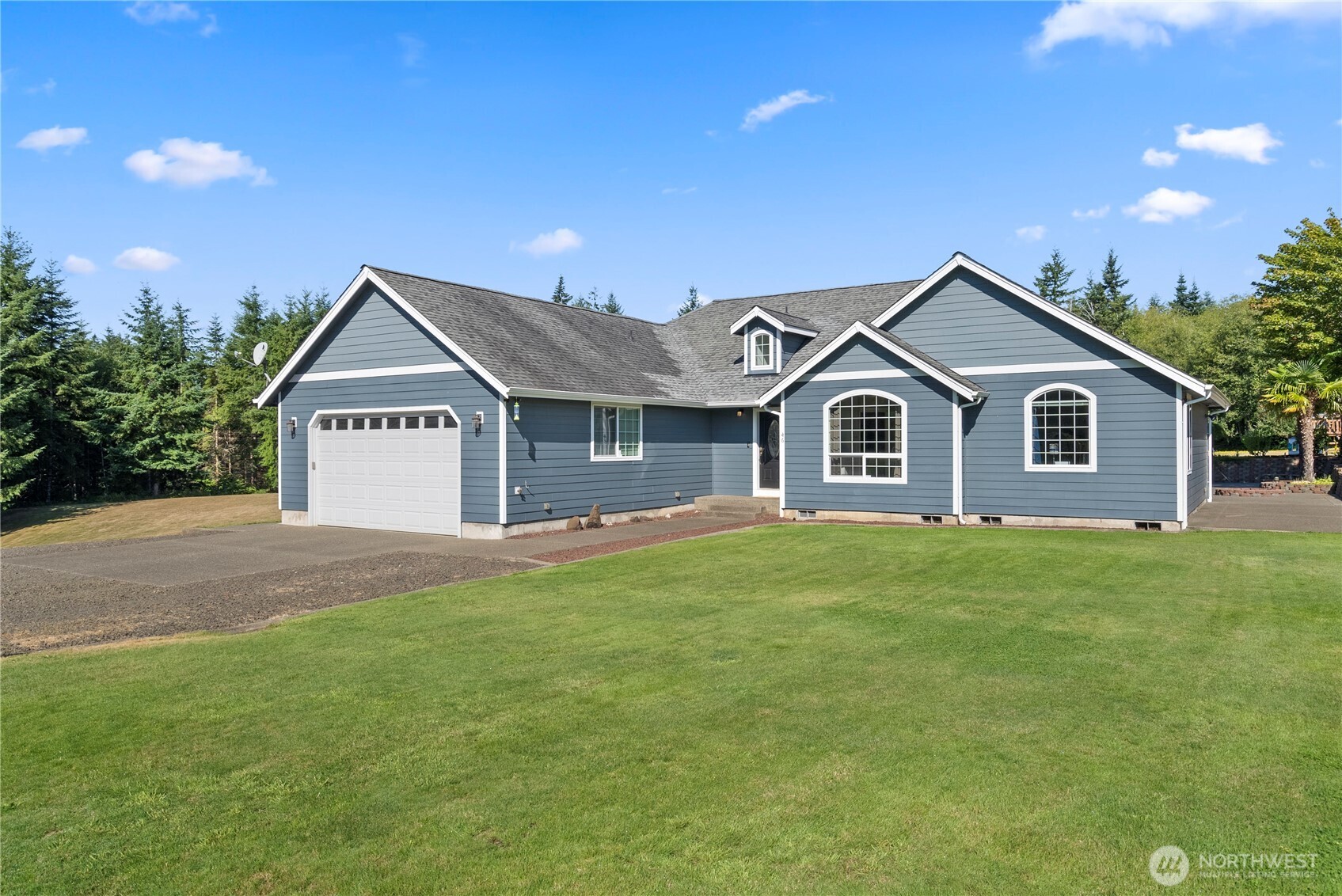 46 Richard Lane Elma, WA 98541 - Photo 2 of 40 a front view of a house with a yard and garage