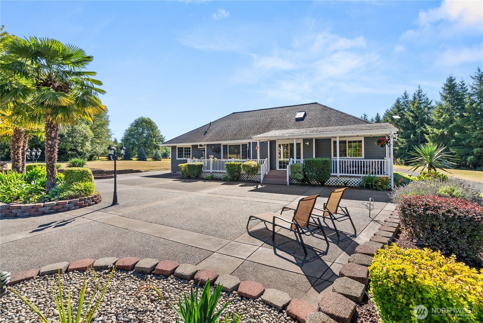 46 Richard Lane Elma, WA 98541 - Photo 22 of 40 a patio area with table and chairs under an umbrella