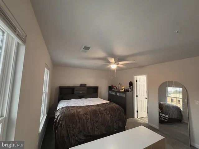 a bedroom with a bed and a view of bedroom