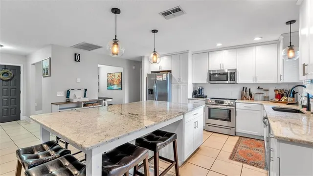 a kitchen with sink cabinets and stainless steel appliances