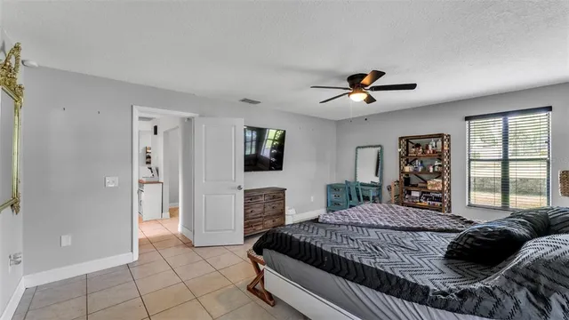 a bedroom with a large bed and a chandelier