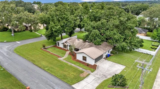 an aerial view of a house with a big yard