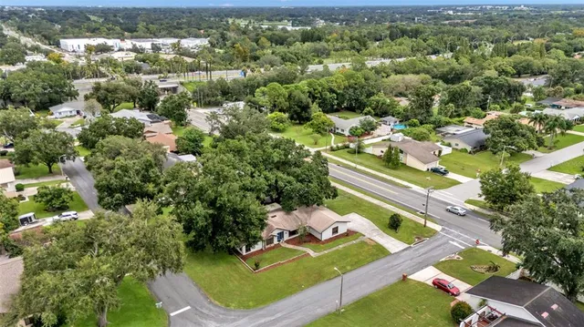 an aerial view of a house with a yard