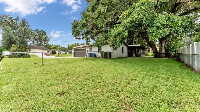 a view of a house with a yard and sitting area
