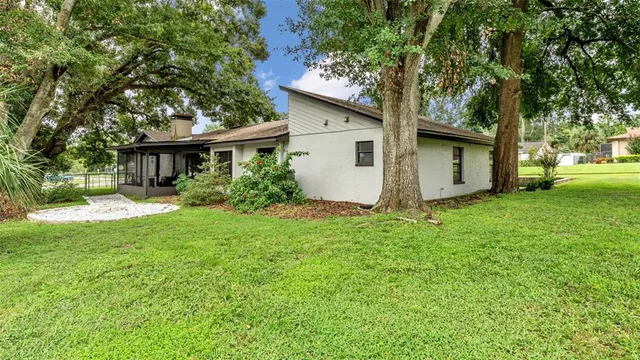 a view of house with backyard and garden