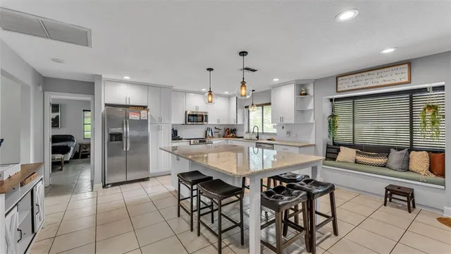 a large kitchen with a table and chairs