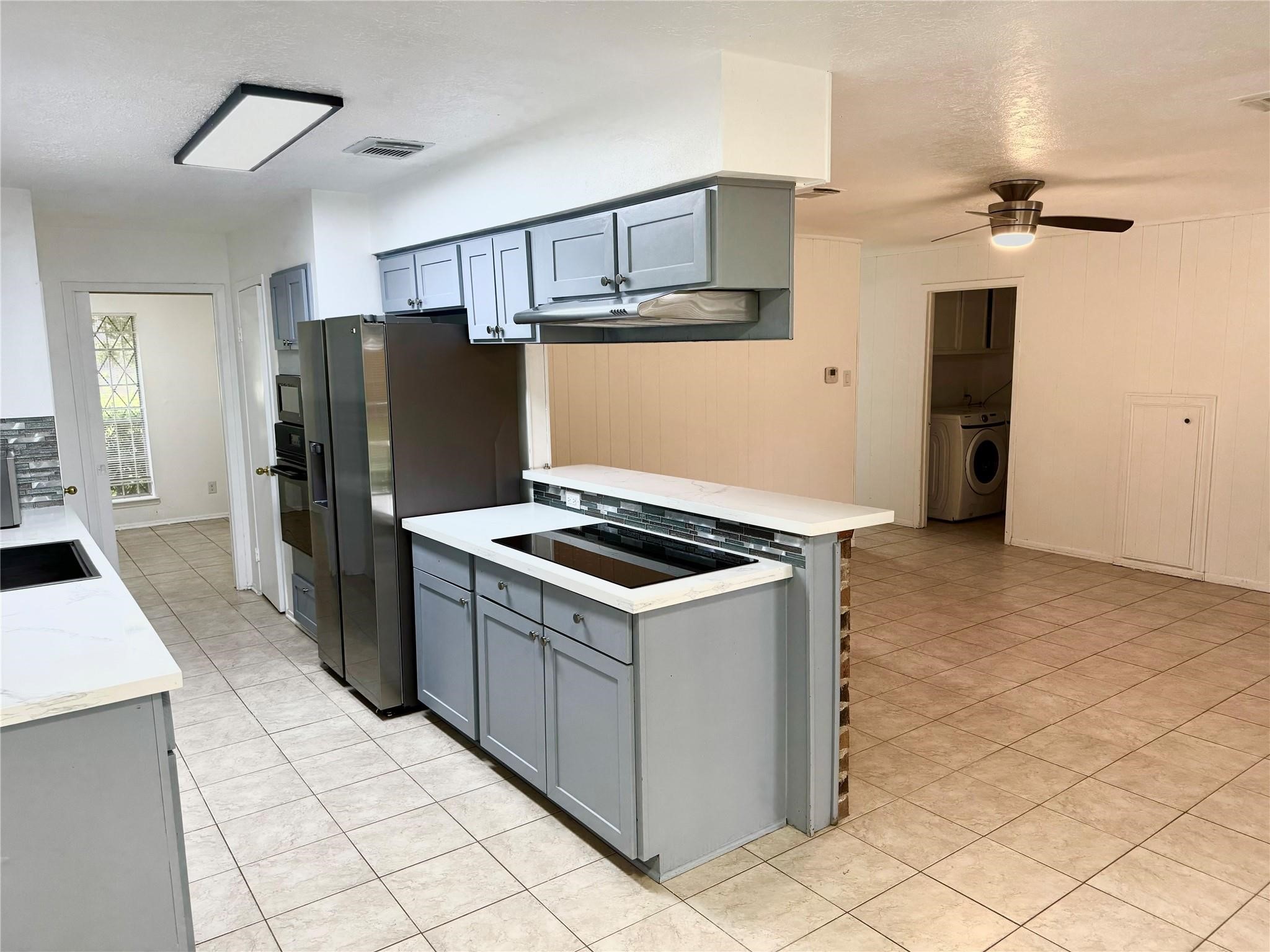 7015 Pyron Way Houston, TX 77036 - Photo 8 of 12 a kitchen with a stove a refrigerator and cabinets