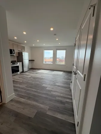 a view of a kitchen from the hallway