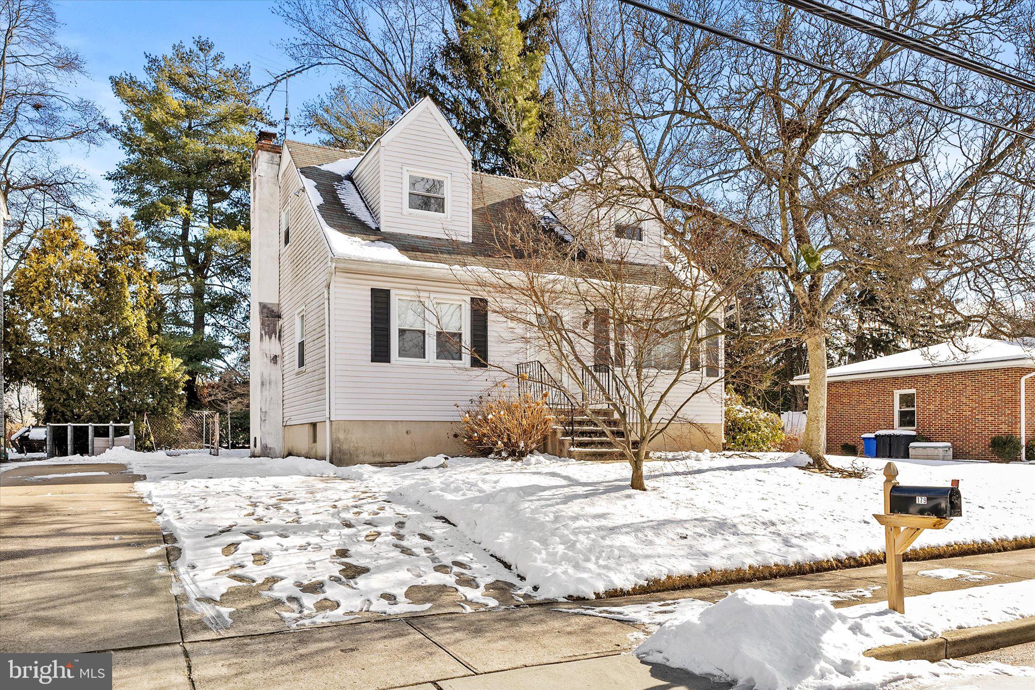 a view of a house with snow on the road