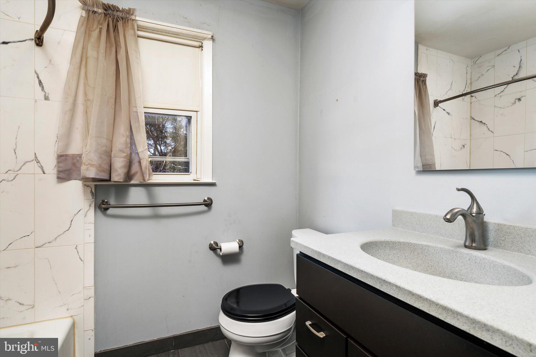 179 Saybrook Avenue Hamilton, NJ 08619 - Photo 13 of 26 a bathroom with a sink a toilet and a mirror
