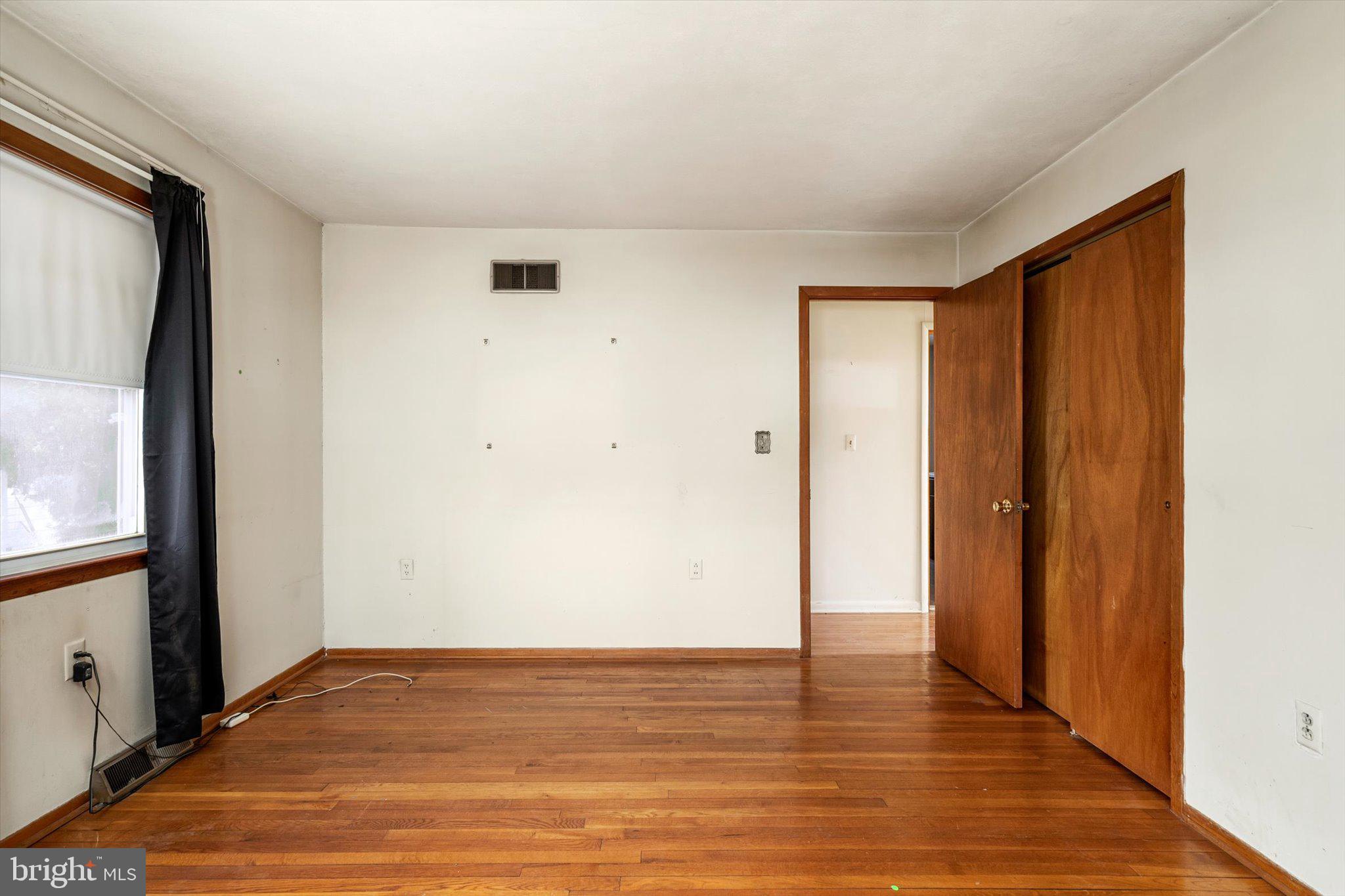 179 Saybrook Avenue Hamilton, NJ 08619 - Photo 18 of 26 a view of an empty room with wooden floor and a window