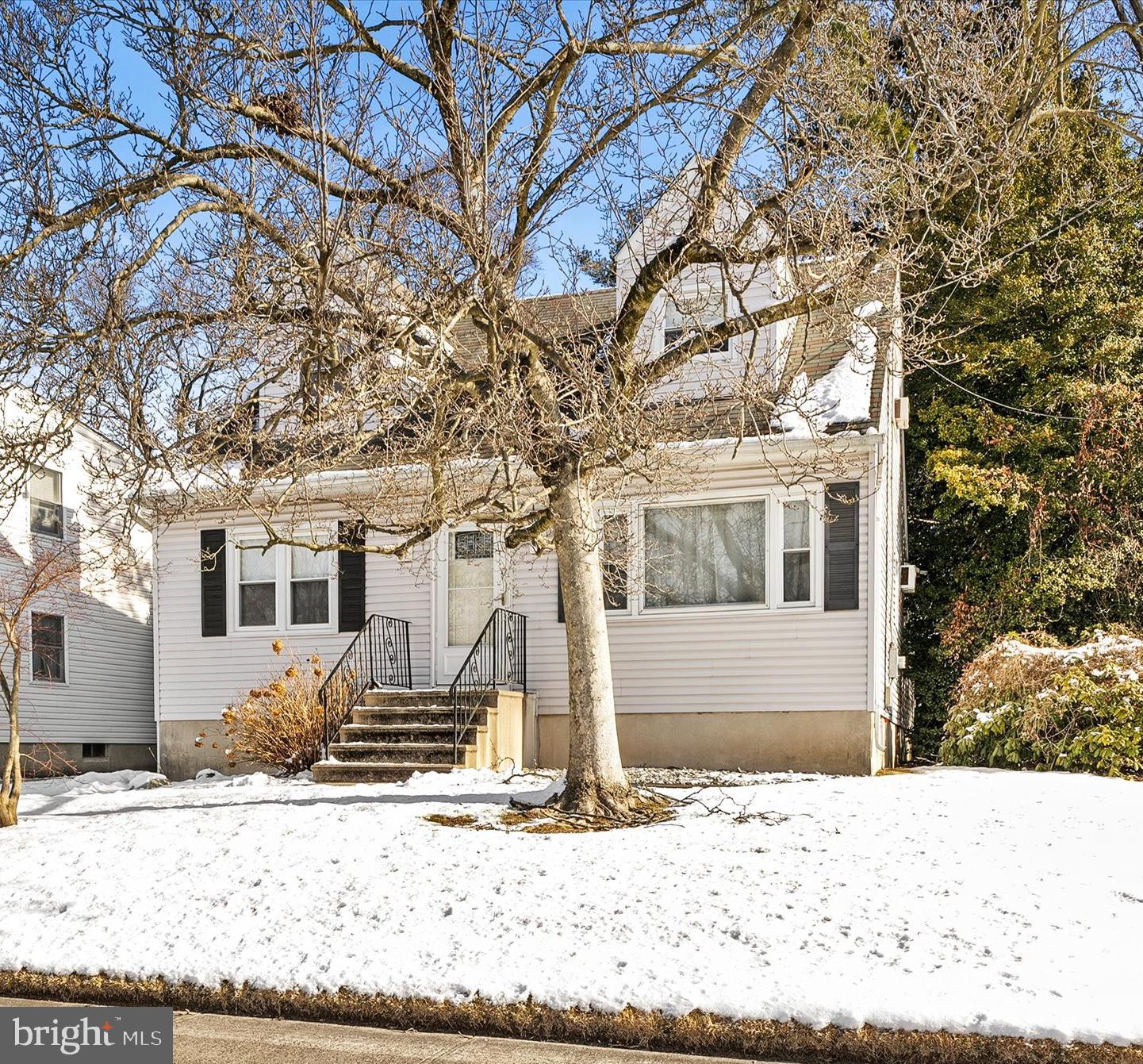 179 Saybrook Avenue Hamilton, NJ 08619 - Photo 2 of 26 a front view of a house with a yard covered in snow