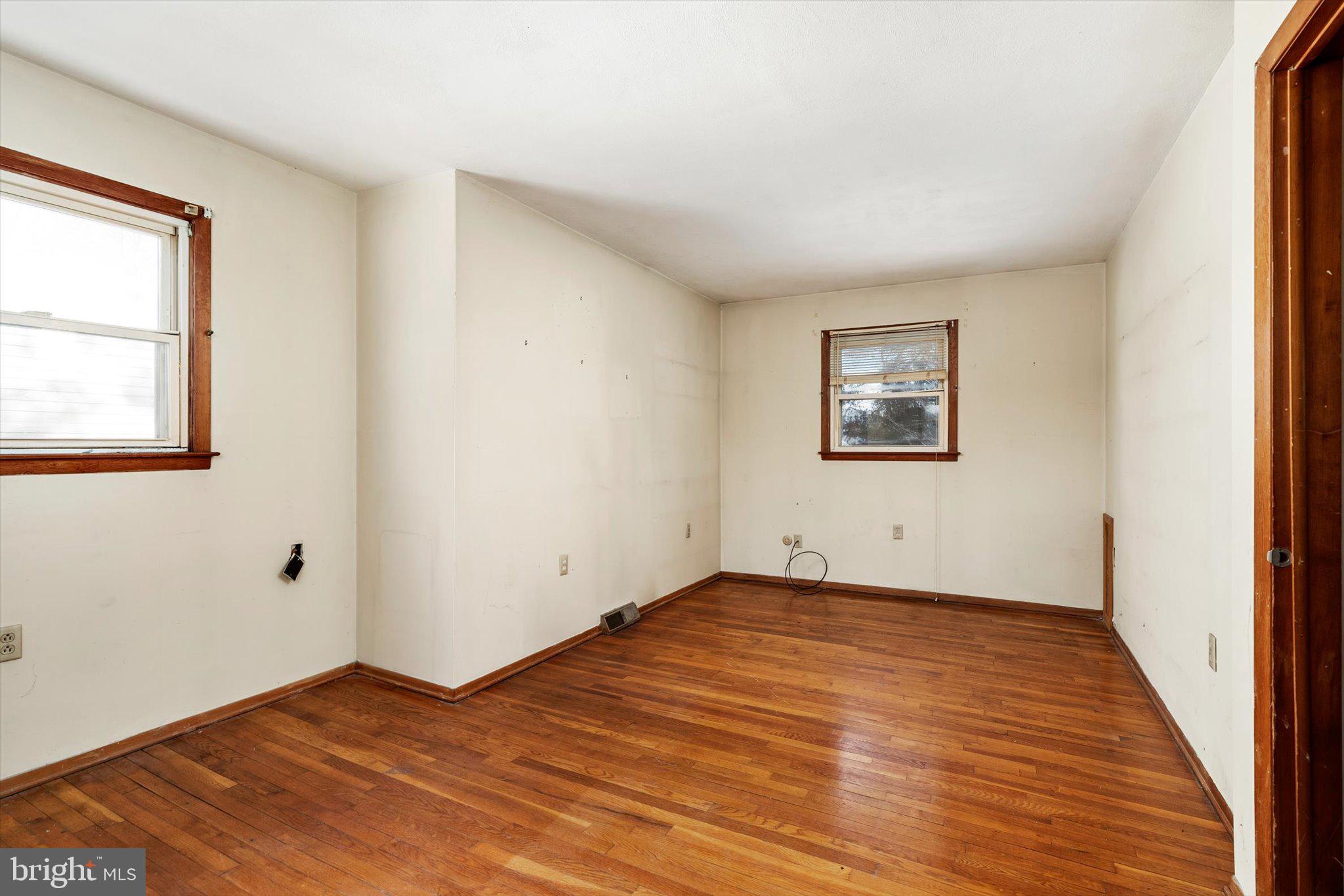 179 Saybrook Avenue Hamilton, NJ 08619 - Photo 22 of 26 an empty room with wooden floor and windows
