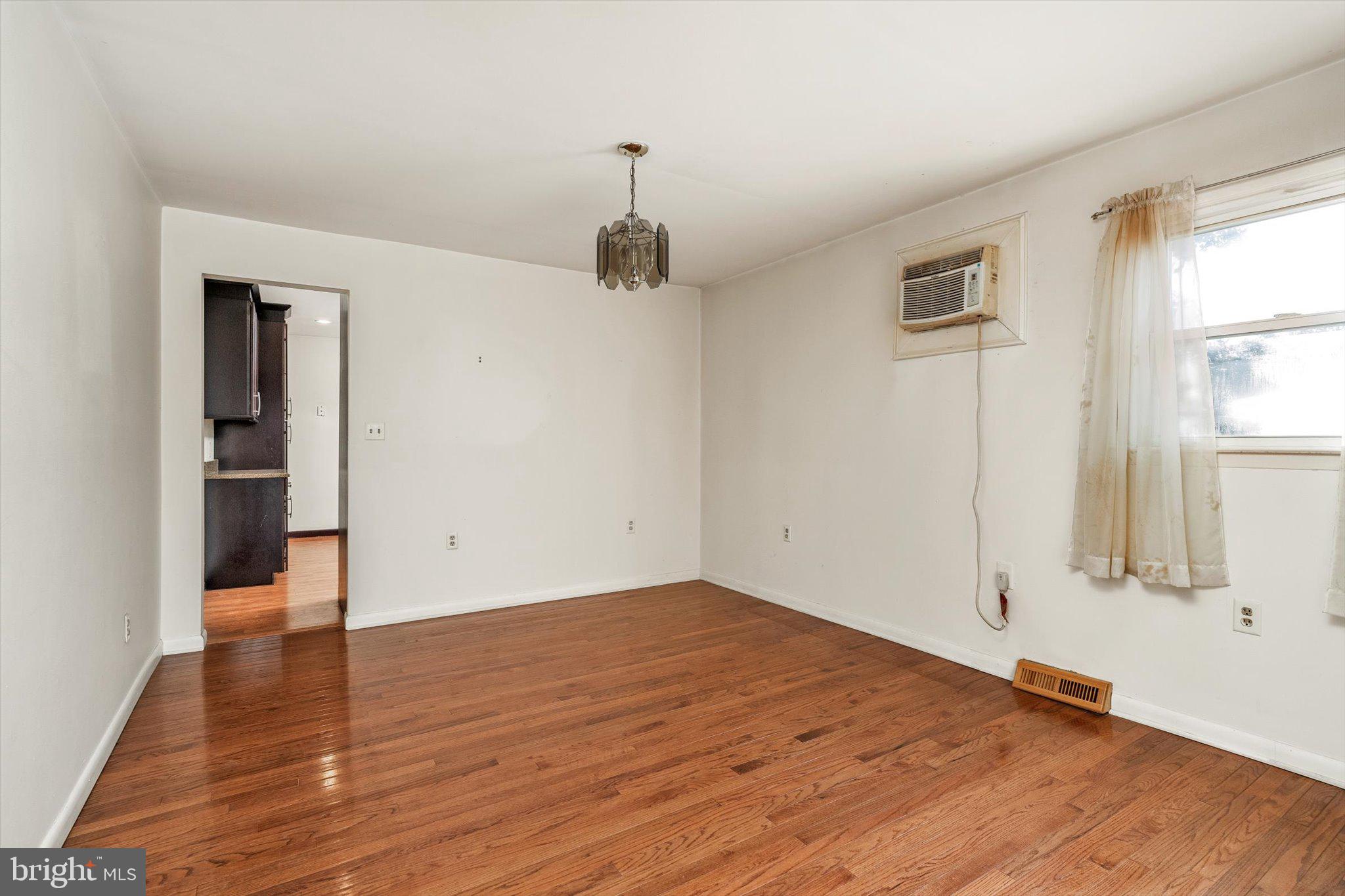 179 Saybrook Avenue Hamilton, NJ 08619 - Photo 6 of 26 an empty room with wooden floor cabinet and windows
