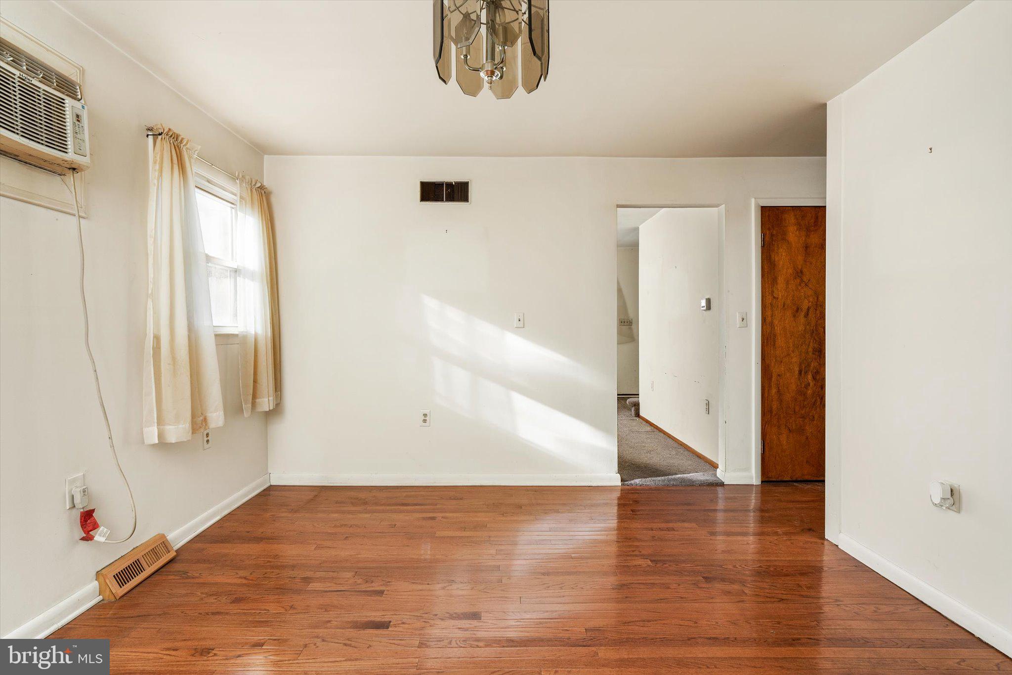 179 Saybrook Avenue Hamilton, NJ 08619 - Photo 7 of 26 an empty room with wooden floor and windows
