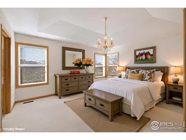 a spacious bedroom with bed and a window