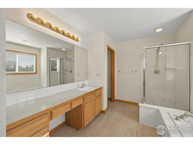 a bathroom with a sink a mirror and a shower