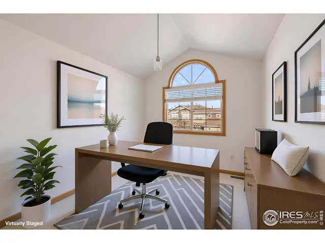 a view of a workspace room with furniture and a potted plant