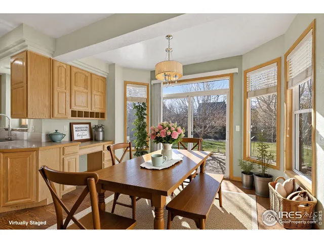 a dining room with furniture a chandelier and wooden floor