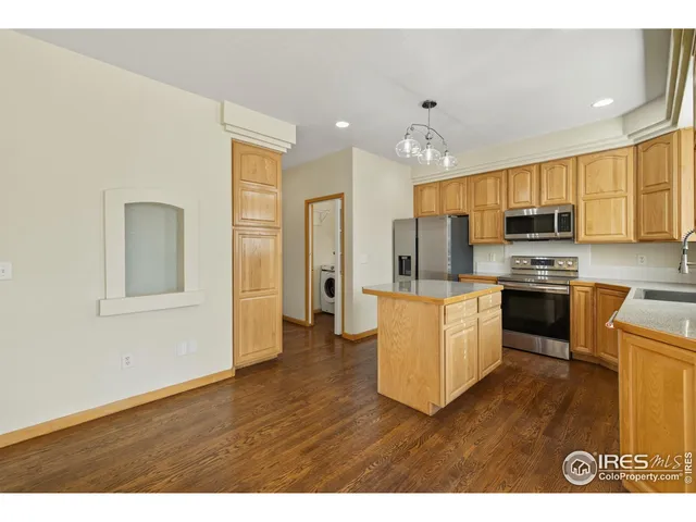 a kitchen with stainless steel appliances granite countertop a refrigerator stove top oven and sink
