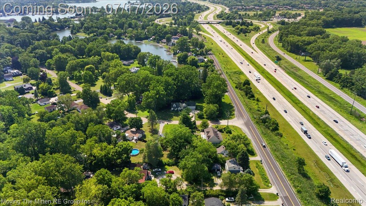 40162 Alden Road Belleville, MI 48111 - Photo 65 of 67 Aerial perspective showcasing an expansive residential area surrounded by mature trees