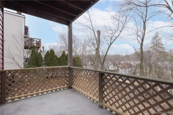 a view of a balcony with trees