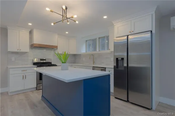 a kitchen with a refrigerator sink and cabinets