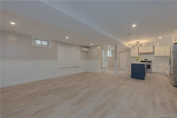 a view of an empty room with kitchen appliances