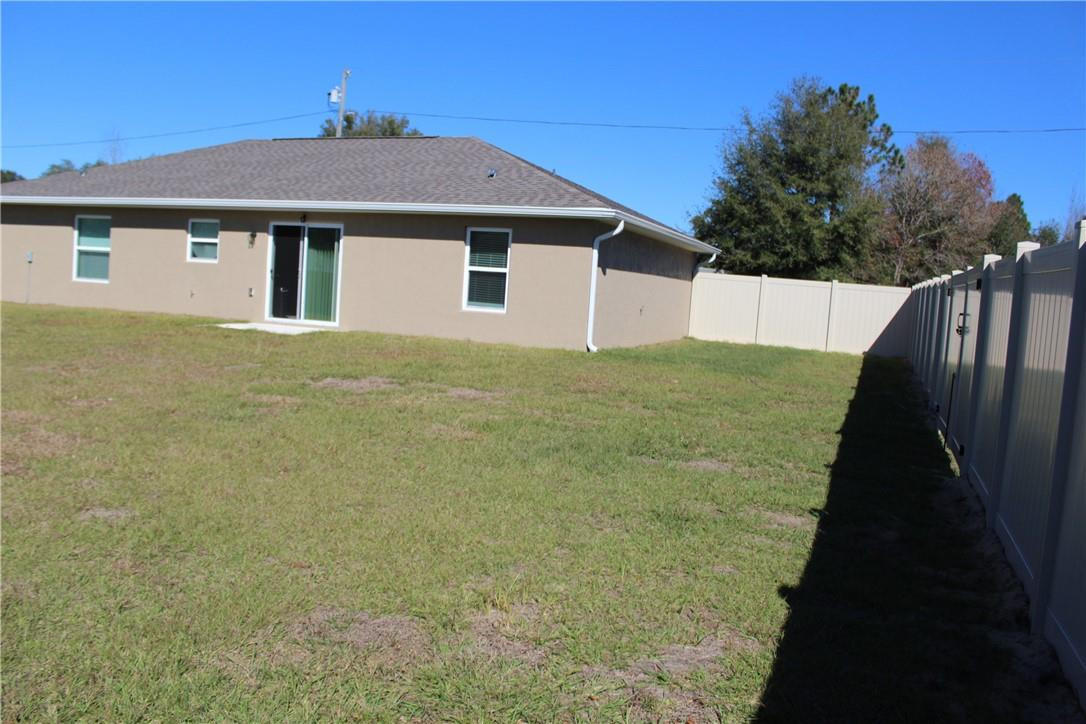 9643 Bahia Road Ocala, FL 34472 - Photo 15 of 16 a house with yard in front of it