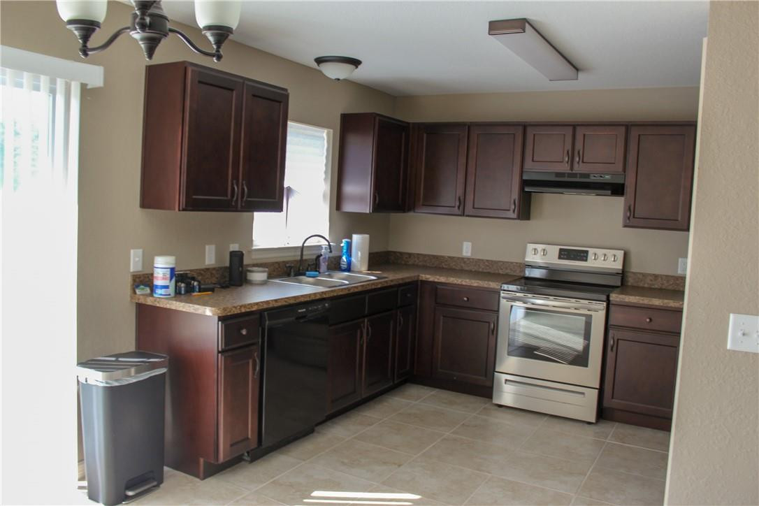 9643 Bahia Road Ocala, FL 34472 - Photo 3 of 16 a kitchen with stainless steel appliances granite countertop a sink stove and cabinets