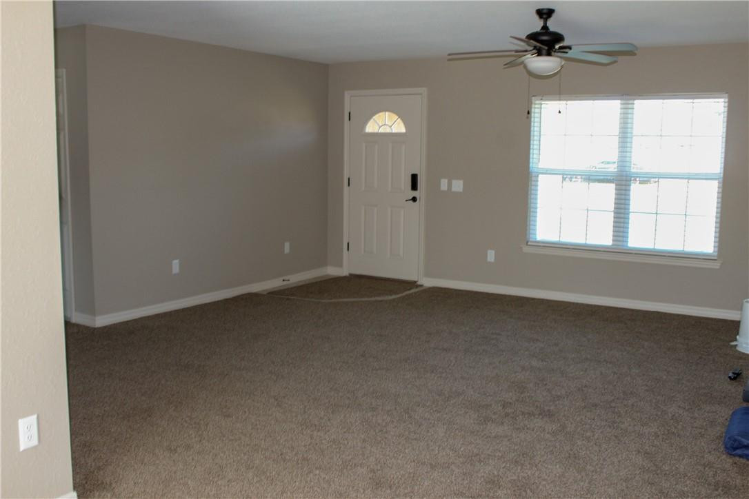 9643 Bahia Road Ocala, FL 34472 - Photo 7 of 16 an empty room with a window and a ceiling fan