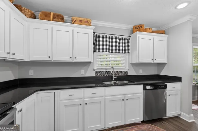 a kitchen with stainless steel appliances granite countertop a refrigerator sink and stove