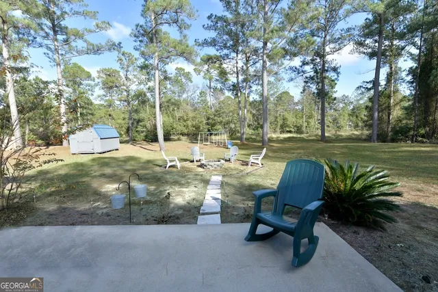 a backyard of a house with table and chairs