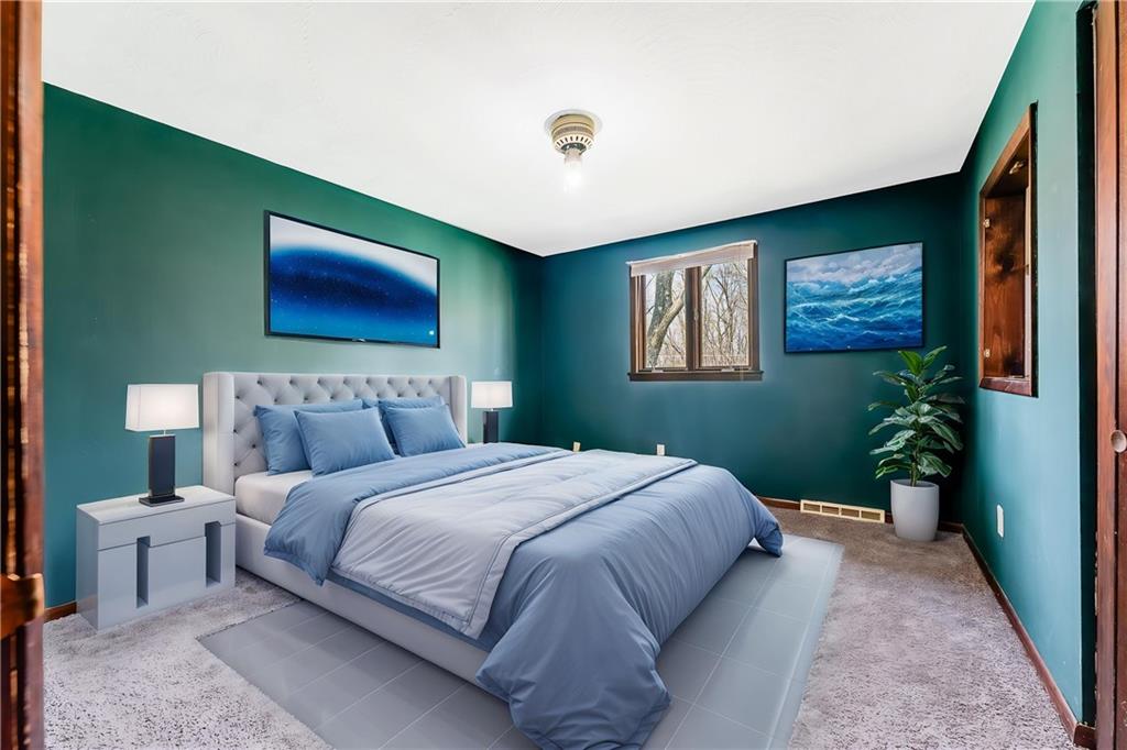 440 Steiner Bridge Road Valencia, PA 16059 - Photo 14 of 45 a bedroom with a bed and a painting on the wall