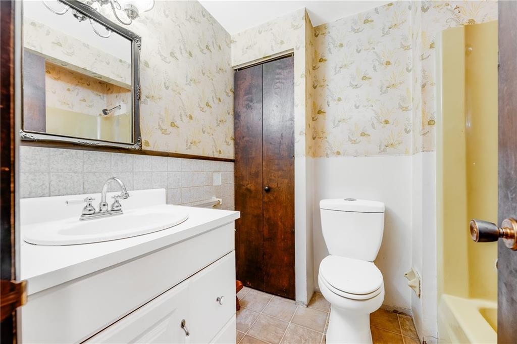 440 Steiner Bridge Road Valencia, PA 16059 - Photo 23 of 45 a bathroom with a toilet sink vanity and mirror