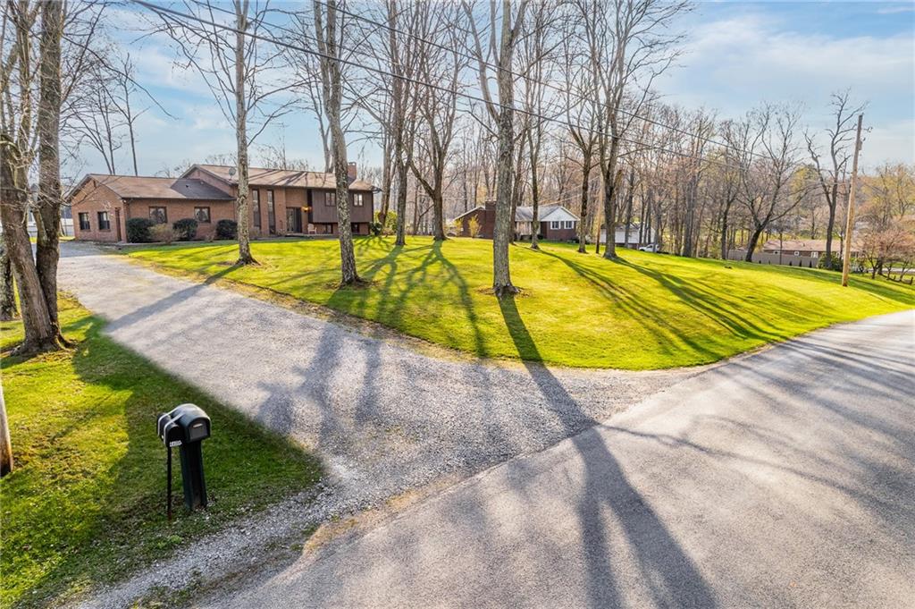 440 Steiner Bridge Road Valencia, PA 16059 - Photo 37 of 45 a view of a swimming pool with a lounge chairs