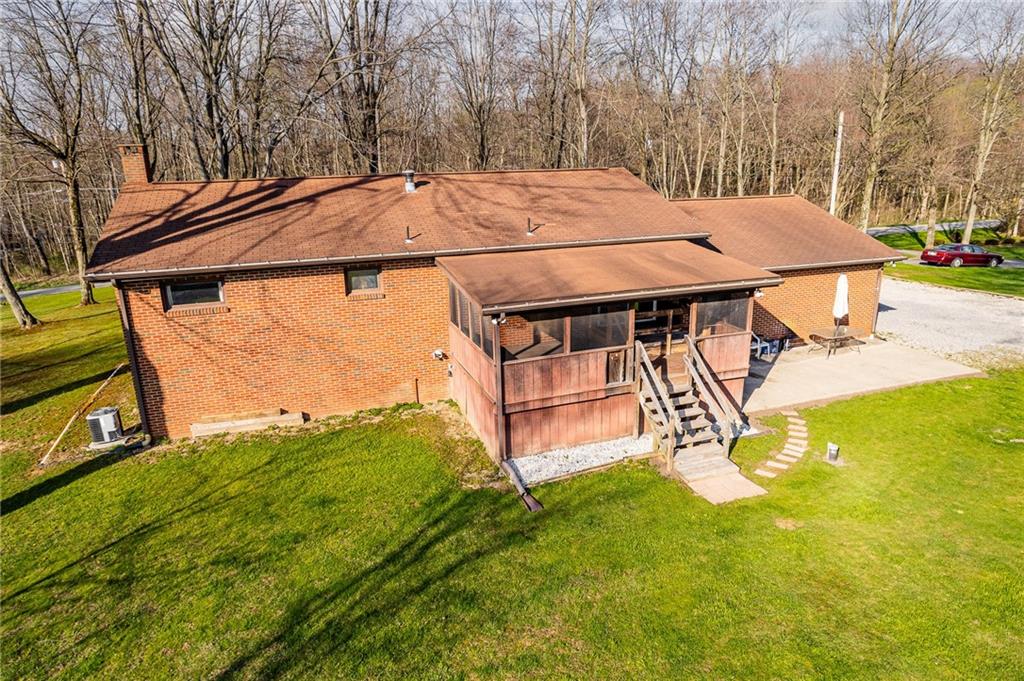 440 Steiner Bridge Road Valencia, PA 16059 - Photo 41 of 45 a view of a backyard with table and chairs under an umbrella with wooden fence